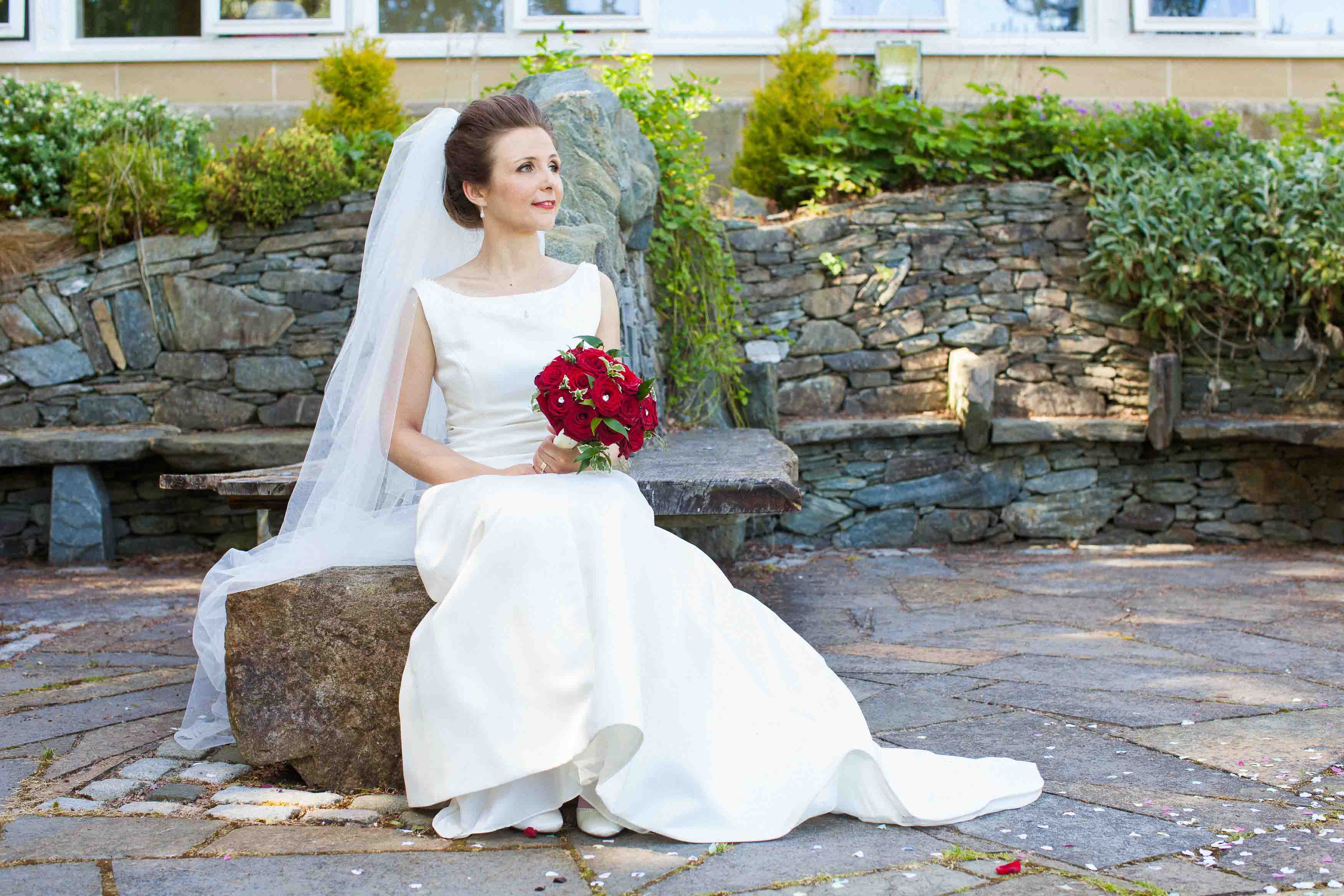 bride setting on stone seat in the rosslea 