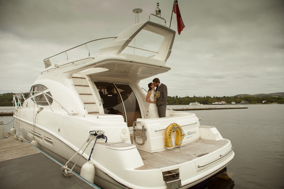 Bride and groom kissing on Boat on Loch Lomond