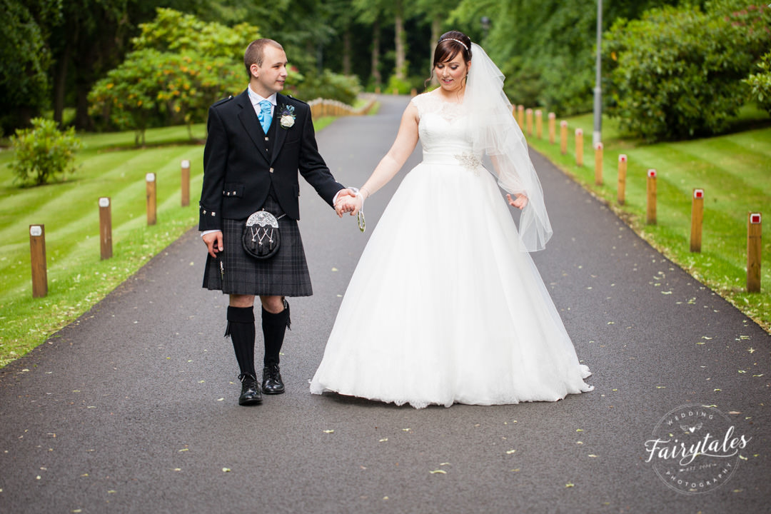 bride and groom walking down macdonald houston house hotel drive