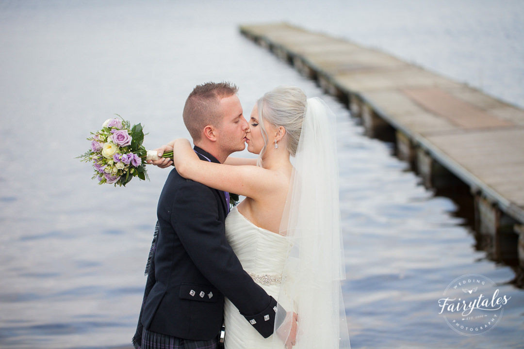 Bride and groom next to Loch Lomond 