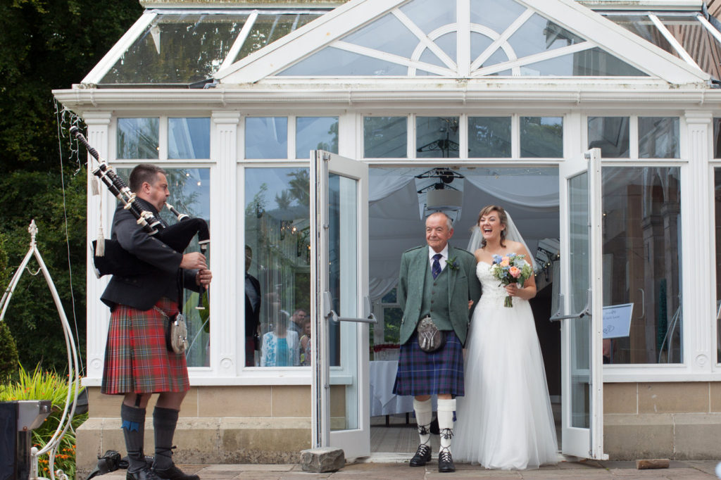 Bride and father walking down the aisle at rosslea hall hotel loch lomond 